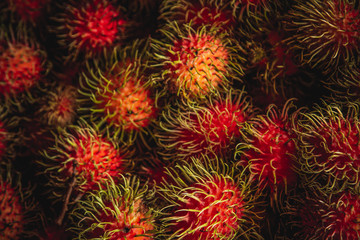 Obraz na płótnie Canvas Healthy fruits rambutans background, Red Healthy fruits rambutans, rambutans in a supermarket 