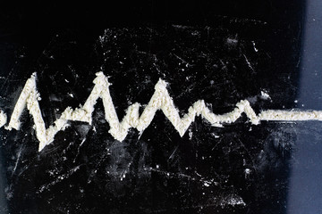 cardiogram, coma, clinical death depicted by cocaine on a shiny black surface