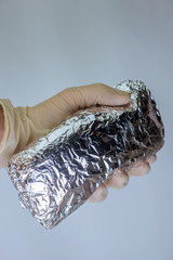 Fototapeta premium medical officer of the laboratory holds in his hand confiscated by the police a package of powder of narcotic substance, for the analysis