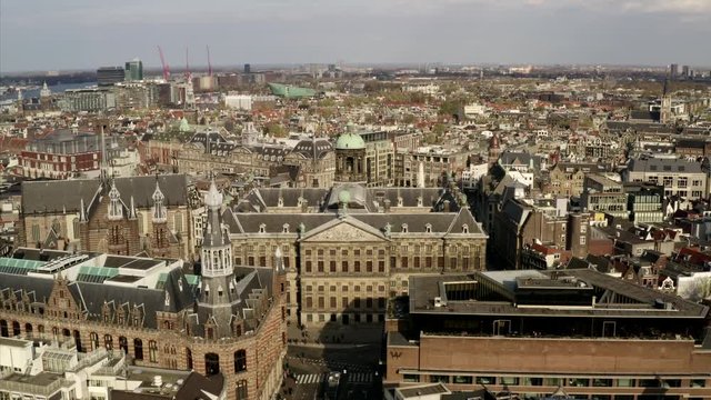 The Paleis op de Dam in Amsterdam, Netherlands on a sunny day. The camera flys slowly backwards and shows the scenery of the Royal Palace.