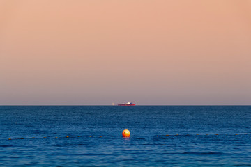 Industrial ships sailing far into the sea.