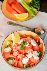 Fototapeta na wymiar Summer light salad of watermelon, lime, mint and cheese