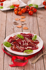 Red heart ravioli with tomato, mozzarella and basil.