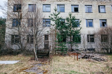 An abandoned building overgrown with trees in Pripyat, the Chernobyl zone