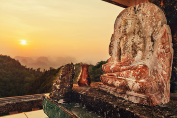 Look on the Krabi province mountains and Buddha from Tiger Cave temple at the sunset