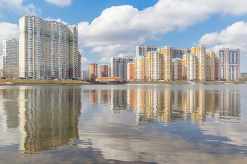 High-rise buildings on the river bank with reflection, Moscow, Russia