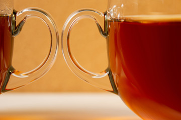 two glass cups of tea on a light background. close-up
