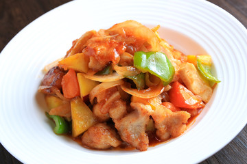 Chinese cuisine: stir-fried chicken with sweet potato, bell pepper, carots seasoned with sweet sour...