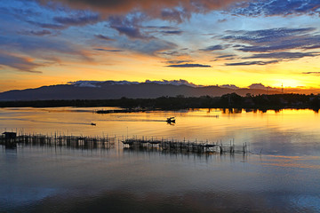 Aquaculture with fishing boats sailing at morning light in Chanthaburi of Thailand