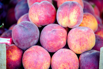 Mature peaches lie on the counter in the store
