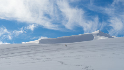 Fototapeta na wymiar The image of a skier on a snowy mountain top.
