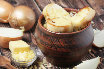 A ceramic pot with French onion soup