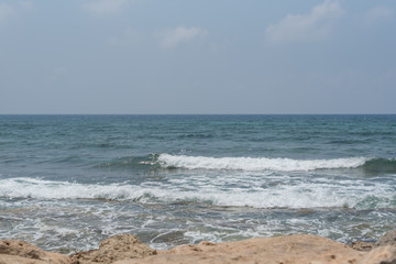 Fototapeta na wymiar Waves on the beach. Clean background. Green storm sea.