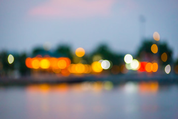 Beautiful blurred city lights with bokeh effect reflected on water