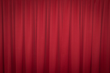 Red closed curtain with a light spot