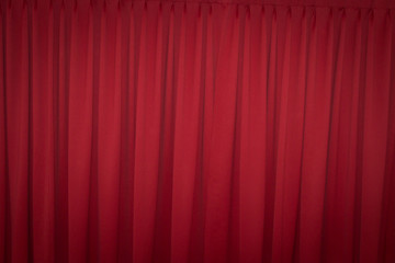 Red closed curtain with a light spot