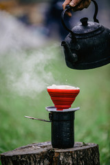 Barista making drip coffee in the camp