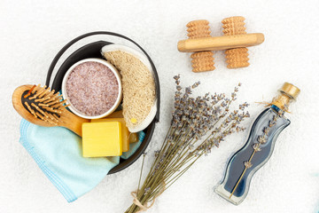Fototapeta na wymiar Natural herbal spa cosmetics with lavender extract - soap, salt, towel, massage brush, washcloth