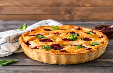 Tasty cherry pie on wooden table