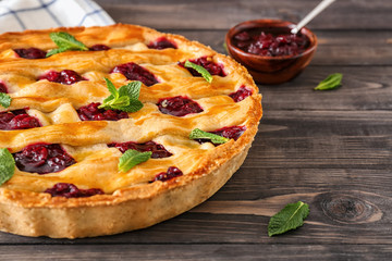 Tasty cherry pie on wooden table, closeup
