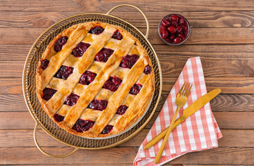 Tasty cherry pie on wooden table