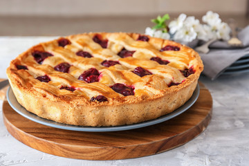 Tasty cherry pie on table