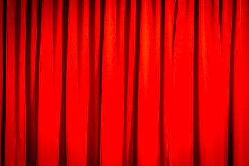 Red closed curtain with a light spot