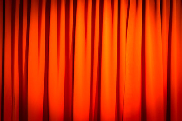 Red closed curtain with a light spot