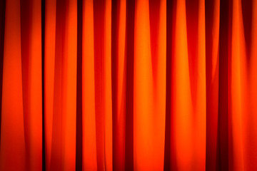Red closed curtain with a light spot