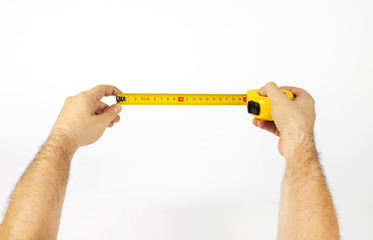 Male hands hold a tape measure to measure the size.