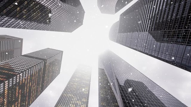 Falling snow on skyscrapers background. Look up at the skyscrapers. Snow falling in New York city on a cold grey day