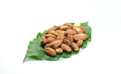 almonds with leaves on white background