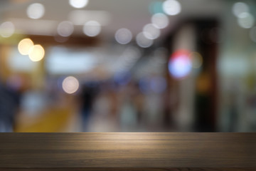 Empty dark wooden table in front of abstract blurred bokeh background of restaurant . can be used for display or montage your products.Mock up for space.