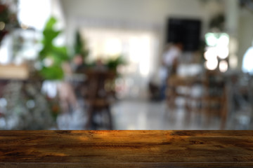 Empty dark wooden table in front of abstract blurred bokeh background of restaurant . can be used for display or montage your products.Mock up for space.