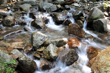 Flowing water of the river beyond Odaki-Medaki waterfall on the Nakasendo road