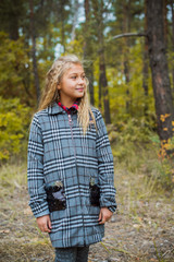 Little fashionable girl in warm clothes walk outdoor, Autumn - Winter season, holidays and children concept. Sweet girl at European street 