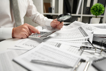 Businessman working at office and calculating finance, reads and writes reports. Business financial...