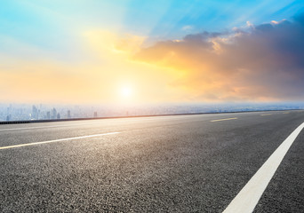 Shanghai city skyline and empty asphalt road scenery at sunrise