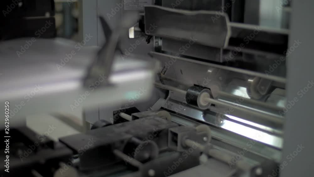 Poster close up shoot of a strip moving sheets on offset printing press machine