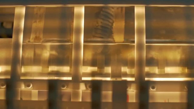 Very Close up Shoot of a Moving Sheets on light,  Offset Printing Press Machine