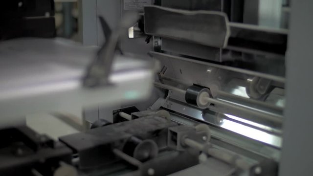 Close up shoot of a Strip Moving Sheets on Offset Printing Press Machine