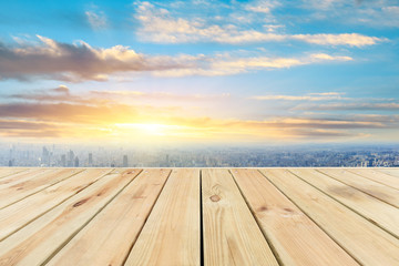 Shanghai city skyline and wooden platform with beautiful clouds scenery at sunset