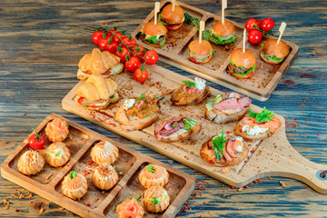 buffet with profiteroles, croissants, meat rolls