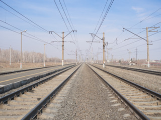Empty railway station, lines and wires, wide angle, selective focus