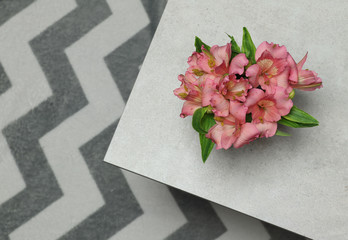 Fresh bouquet flowers alstroemeria placed on grey stone desk
