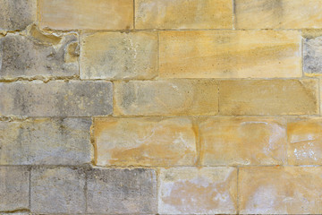 Mur de vieilles pierres douceur jaune et grise