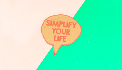 simplify your life speech bubble isolated on green and blue background