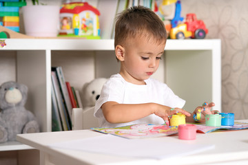 child draws paints fingers