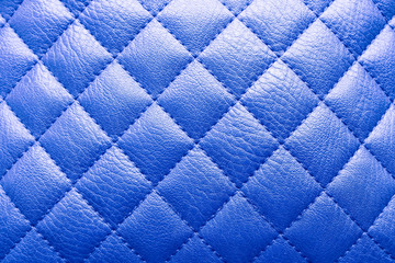 Fototapeta premium Proton purple colored leather texture with rhombus. Background for sofa interior or door.