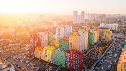 panoramic aerial view of colorful (red, green, blue, yellow) buildings on city street. drone shot